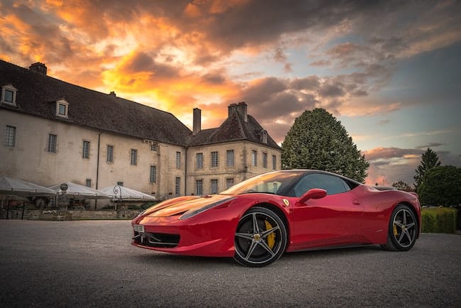 Ferrari parked. outside an Italian villa